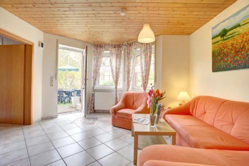 a living room with two couches and a table at Apartment Liesertal in Weiersbach