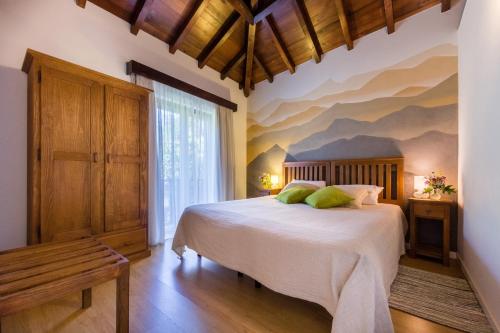 a bedroom with a bed with a mountain mural on the wall at Quinta da Pousadela - Agroturismo in Amarante