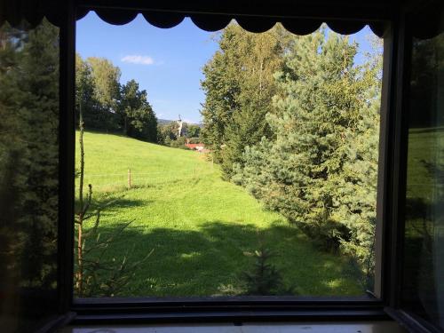 a view of a field from a window at Chalupa Herman in Rudník