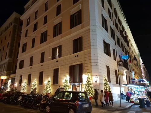 a building with christmas trees in front of it at Casa De Rose in Rome