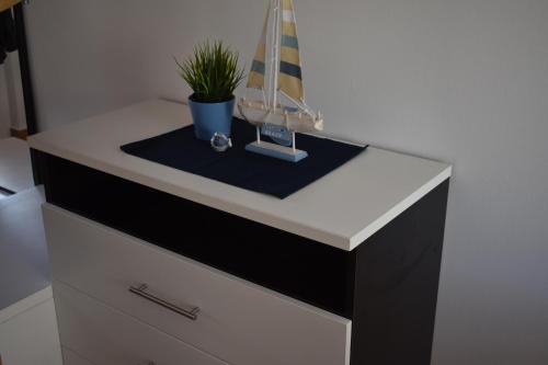 a dresser with a sailboat on top of it at Holiday house Matej in Vir