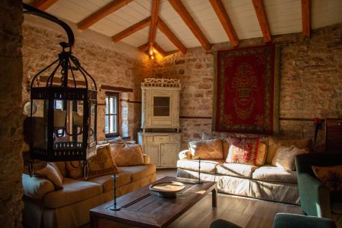 a living room with two couches and a table at Epoches Luxury Suites in Karpenision