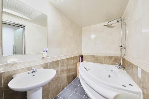 a bathroom with a sink and a bath tub at K2 Motel in Seoul