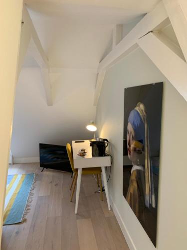 a room with a table and a painting on the wall at Kangaroom in Amsterdam