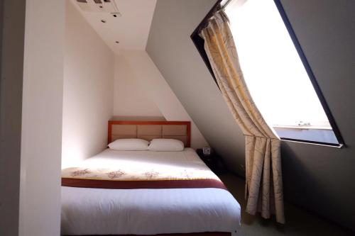 Ένα ή περισσότερα κρεβάτια σε δωμάτιο στο Tabata Oji Hotel
