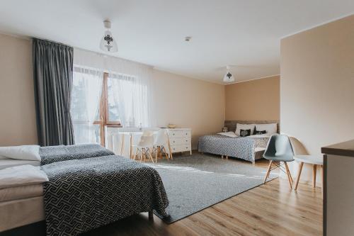 מיטה או מיטות בחדר ב-Hotel Majerzanka