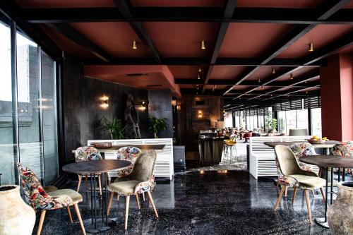 a restaurant with tables and chairs in a lobby at Carus Cappadocia in Goreme