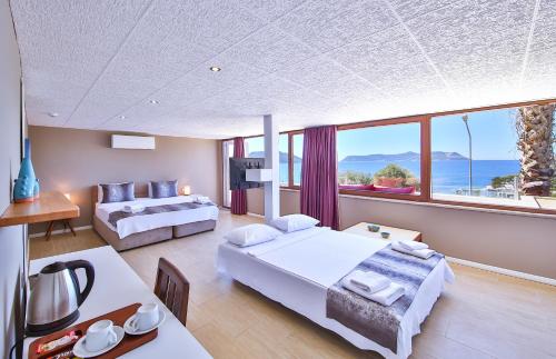 a bedroom with two beds and a large window at Hotel No37 in Kas