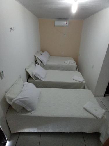 a room with four beds in a room at Pousada Bela Vista de Mateiros in Mateiros