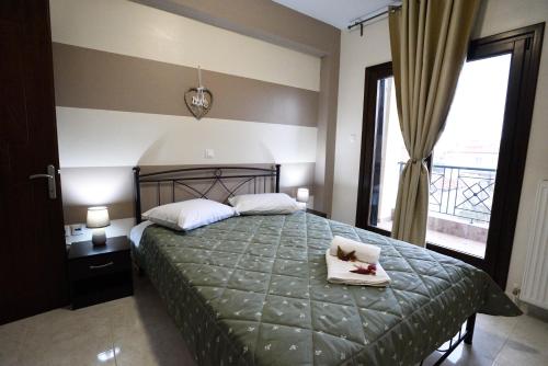 a bedroom with a bed with two towels on it at San Giorgio Luxury Apartments in Ierissos