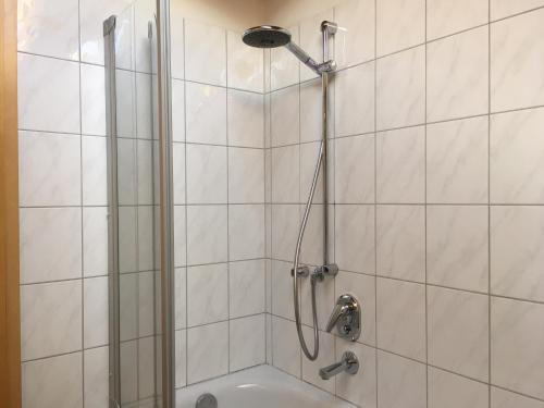 a shower with a glass door in a bathroom at ALPENFREUND in Mittenwald