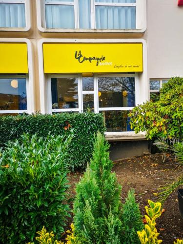 a store front of a building with a yellow sign at ibis Belfort Danjoutin in Belfort
