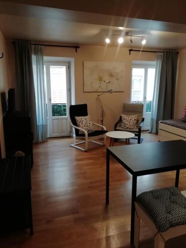 a living room with two chairs and a table at Apartamento Sebreñu 1 in Ribadesella
