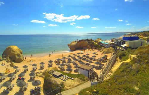 a beach with a bunch of umbrellas and the ocean at Casa da Eira - Private Villa - pool - Free wi-fi - Air Con in Silves