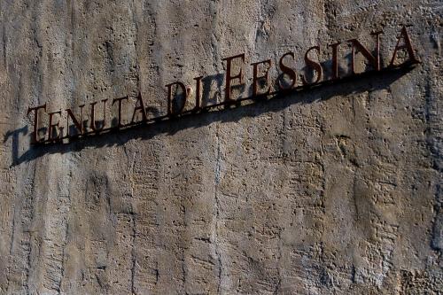 a sign on the side of a brick wall at Tenuta di Fessina in Castiglione di Sicilia