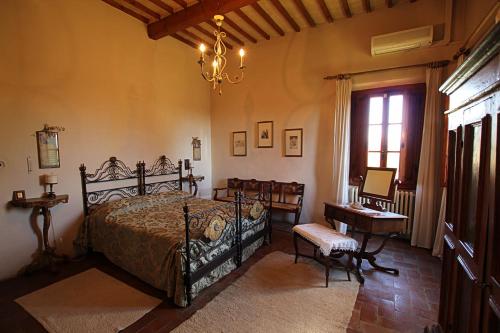 a bedroom with a bed and a table and a window at Villa Del Rimedio in Fucecchio