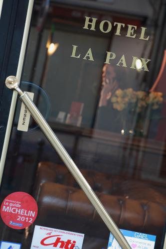 a metal pole in front of a hotel la park at Hotel De La Paix in Lille