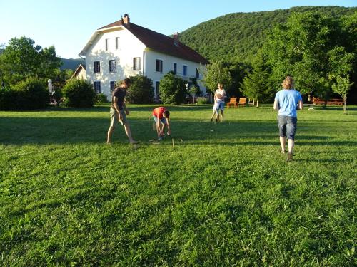 a group of people playing frisbee in a field at Goute la vie in Marchamp