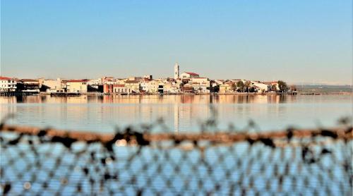 a body of water with a city in the background at Agriturismo Masseria Cannella in Lesina