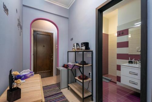 a bathroom with purple walls and a sink and a mirror at Tonias house in Athens in Athens