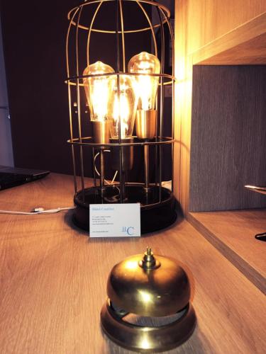 a lantern with candles on top of a table at Hotel Courbet in Juan-les-Pins