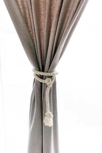 a gray curtain with a knot in it at Steira-Studios in Ehrenhausen