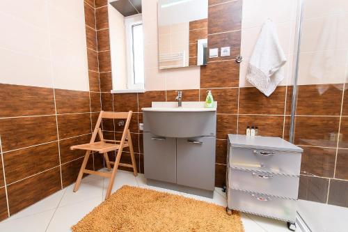 a bathroom with a sink and a mirror at Apartment Carlo 7D in Veľký Slavkov