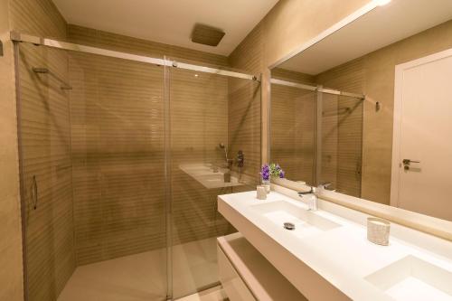 a bathroom with two sinks and a shower at Sunset Drive Benidorm by Mar Holidays in Benidorm