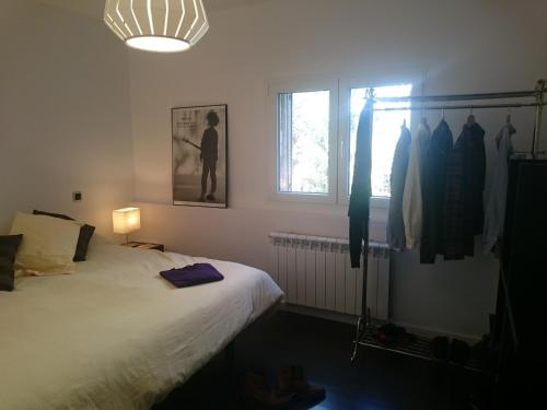 a bedroom with a bed and a window at Casa Piedra Libre in Manzanares el Real