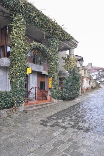 a building with ivy on the side of a street at Villa Forum in Ohrid