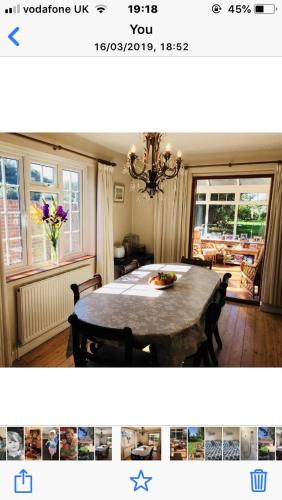 a dining room with a table with chairs and a dining room at Barnfield Bed and Breakfast in Downton