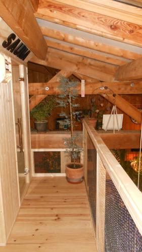 a wooden walkway with a potted plant in a house at Domaine de Sault in Dore-lʼÉglise