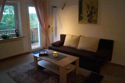 ein Wohnzimmer mit einem Sofa und einem Couchtisch in der Unterkunft Ferienwohnung Shamrock in Hahnenklee-Bockswiese