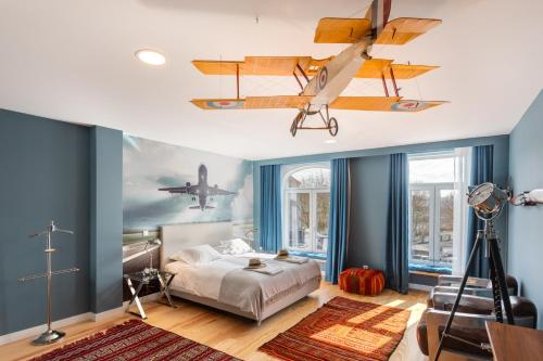 a bedroom with a bed and airplanes on the ceiling at Casa da Praça in Porto