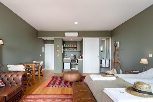 a living room with a couch and a table at VIVA Casa da Praça with heated Pool and Terrace in Porto