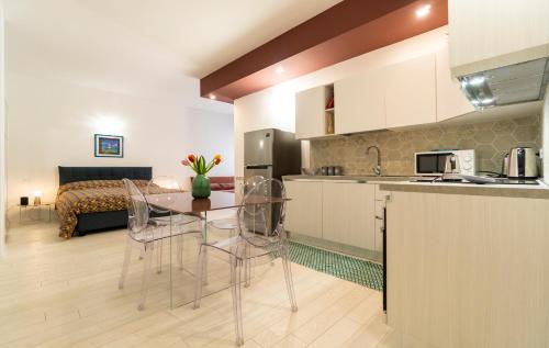 a kitchen with a table and chairs and a bed at Residence Cairoli 9 by Studio Vita in Bologna