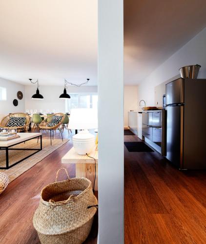 a kitchen and living room with a stainless steel refrigerator at BeachLiving Cortegaça in Cortegaça