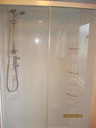 a shower stall with a glass door in a bathroom at 27 The Beeches, Gilcrux, Nr Cockermouth, Cumbria in Gilcrux