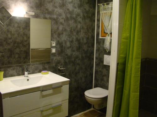 a bathroom with a sink and a toilet and a mirror at Villa Ardilla - Classée 3 étoiles -Grand confort et bien-être à proximité immédiate du centre du village et des commerces in Canet