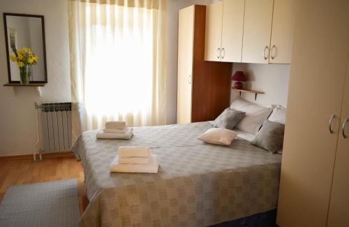 a bedroom with a bed with two towels on it at Holiday Apartment Vrsar in Vrsar