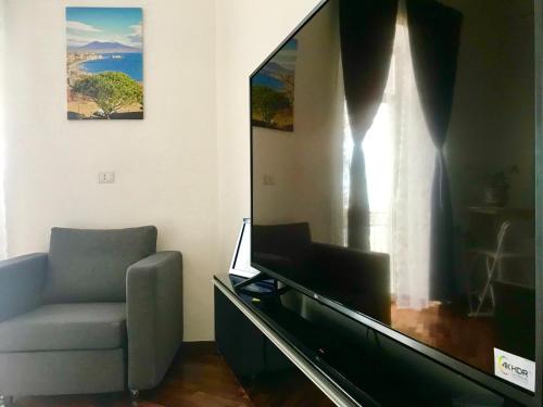 a living room with a couch and a large screen tv at Casa Annamaria in Naples
