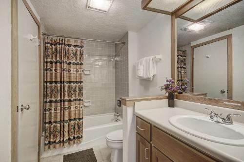 a bathroom with a sink and a toilet and a shower at 2062 The Pines Condo in Keystone