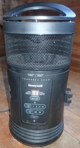 a black rice cooker sitting on a wooden floor at Quetzal Valley Cabins in San Gerardo de Dota