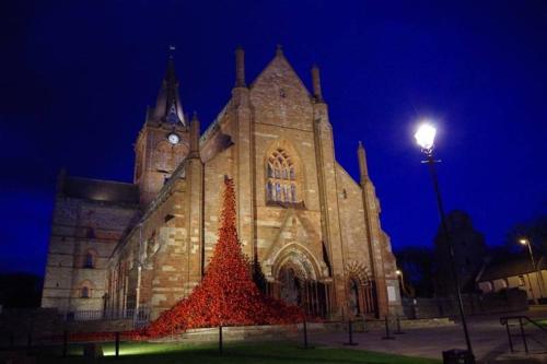 a large church with a clock tower at night at Ardconnel Bed and Breakfast in Kirkwall