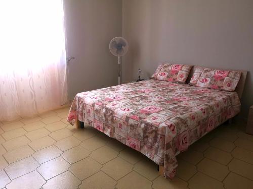 a bedroom with a bed and a fan at Holiday House in Taviano