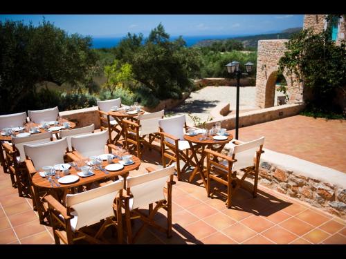 a group of tables and chairs on a patio at Pandora in Pirgos Dhirou