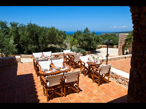 a group of tables and chairs on a patio at Pandora in Pirgos Dhirou