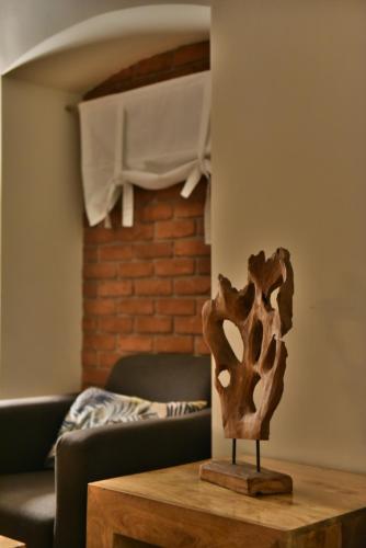 a wooden sculpture on a wooden table in a room at Hotel Stara Kamienica in Piekary Śląskie