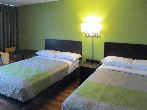 a hotel room with two beds and a lamp at Motel 6-Chilhowie, VA in Chilhowie