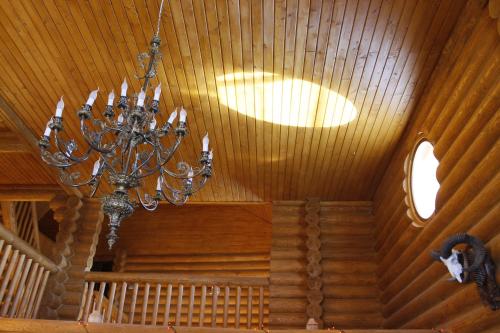 a chandelier is hanging from a wooden ceiling at Honor Villa in Izvoare